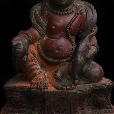 Lot 61 - A Tibetan painted bronze figure of Kubera