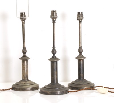 Lot 476 - A set of three brass table lamps