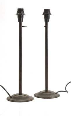 Lot 475 - A pair of patinated brass table lamps