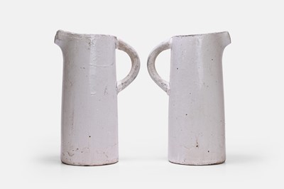 Lot 124 - A pair of glazed terracotta jugs