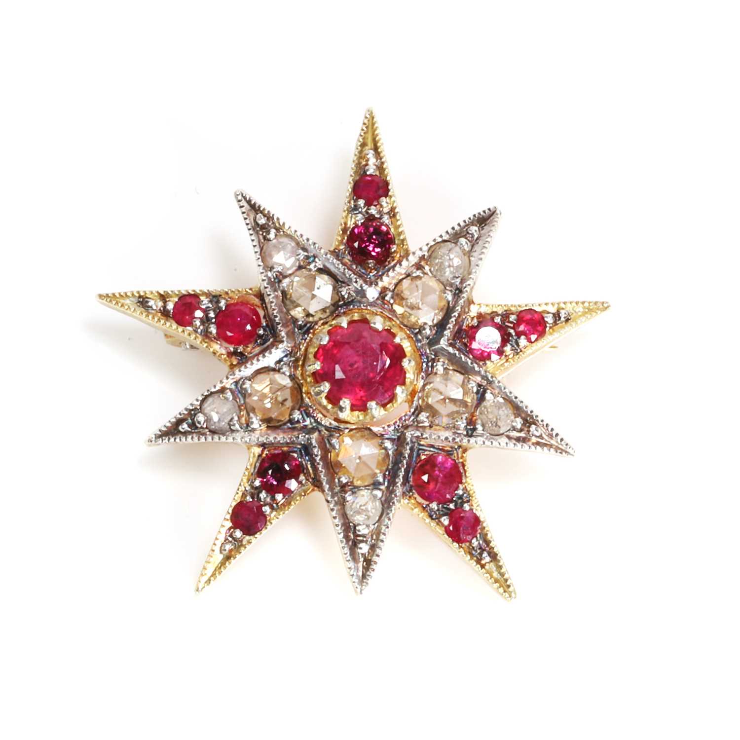 Lot 77 - A silver gilt ruby and diamond star pendant/brooch