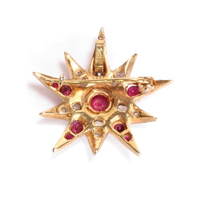 Lot 77 - A silver gilt ruby and diamond star pendant/brooch