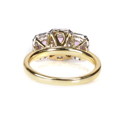 Lot 101 - An 18ct gold pink sapphire and diamond triple cluster ring