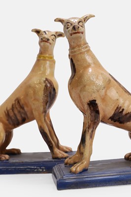Lot A pair of faience greyhound figures
