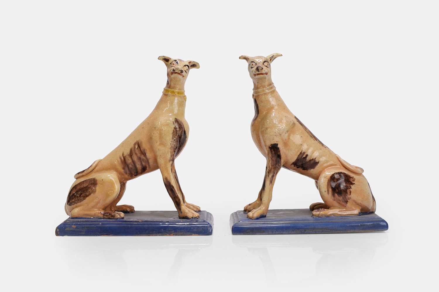 Lot A pair of faience greyhound figures