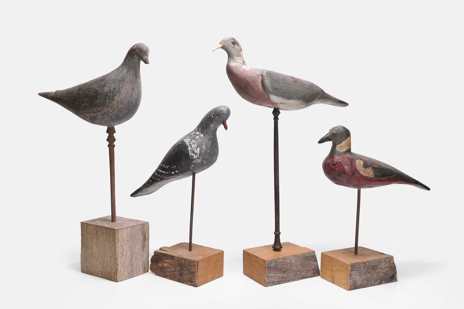 Lot 119 - A flight of four wooden decoy pigeons