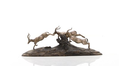 Lot 12 - A silver and wood model of leaping impalas