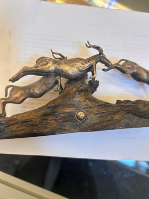 Lot 12 - A silver and wood model of leaping impalas
