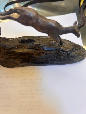 Lot 12 - A silver and wood model of leaping impalas