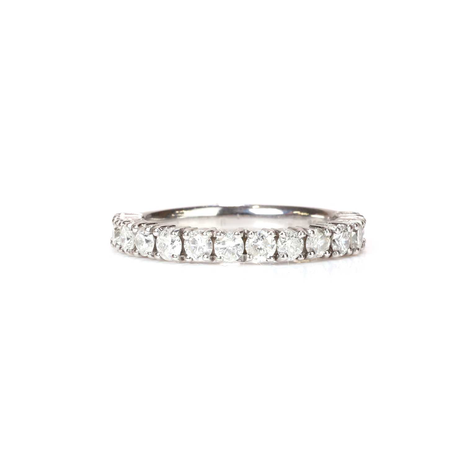 Lot 52 - A platinum and diamond three quarter eternity ring