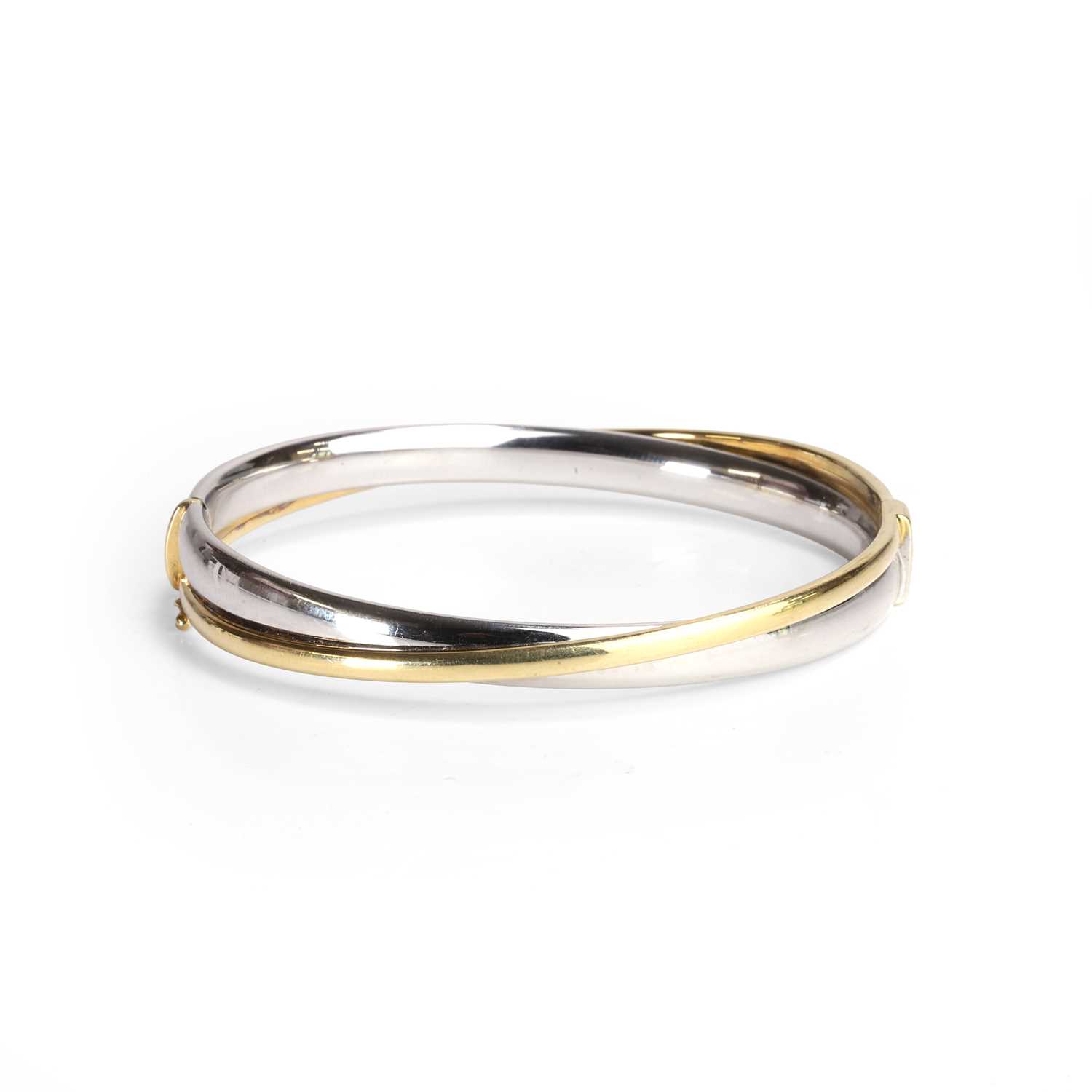 Lot 96 - A bi-coloured 18ct gold bangle