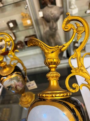 Lot 106 - A pair of ormolu-mounted porcelain ewers
