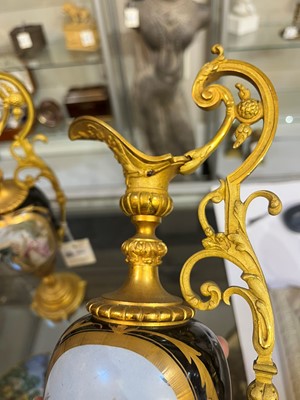 Lot 106 - A pair of ormolu-mounted porcelain ewers