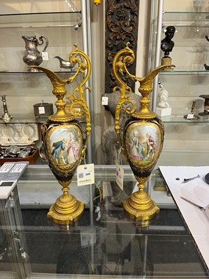 Lot 106 - A pair of ormolu-mounted porcelain ewers