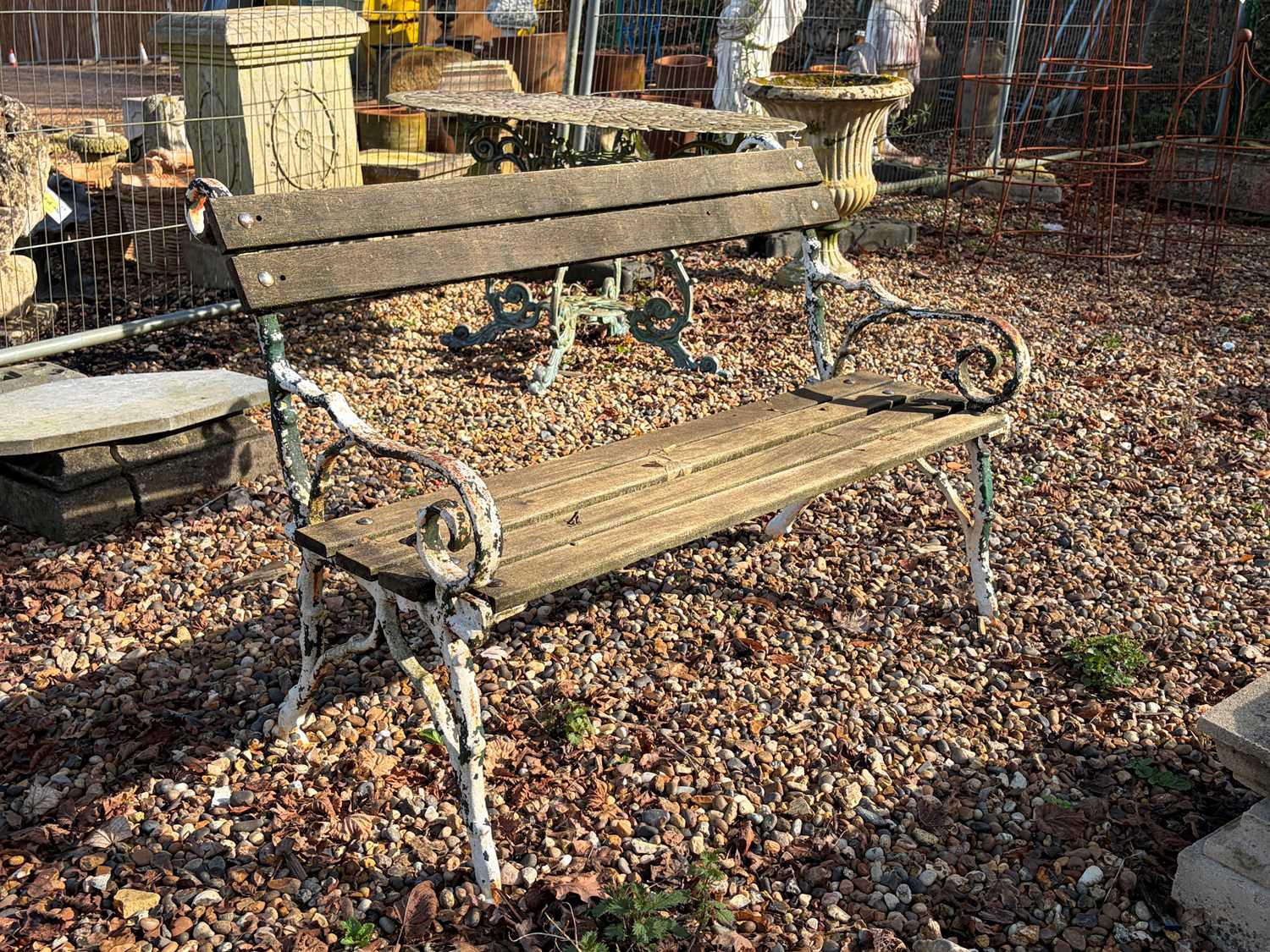 Lot 556 - A painted cast iron and wooden bench