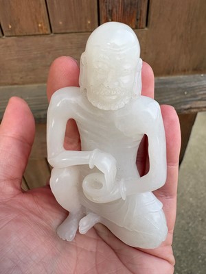 Lot 57 - A small Chinese carved jade figure of an emaciated Luohan