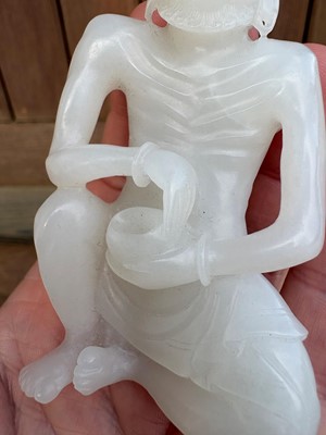 Lot 57 - A small Chinese carved jade figure of an emaciated Luohan