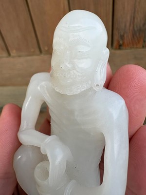 Lot 57 - A small Chinese carved jade figure of an emaciated Luohan