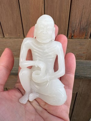 Lot 57 - A small Chinese carved jade figure of an emaciated Luohan
