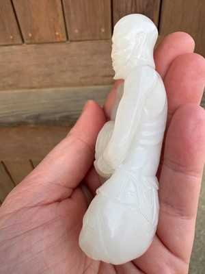 Lot 57 - A small Chinese carved jade figure of an emaciated Luohan