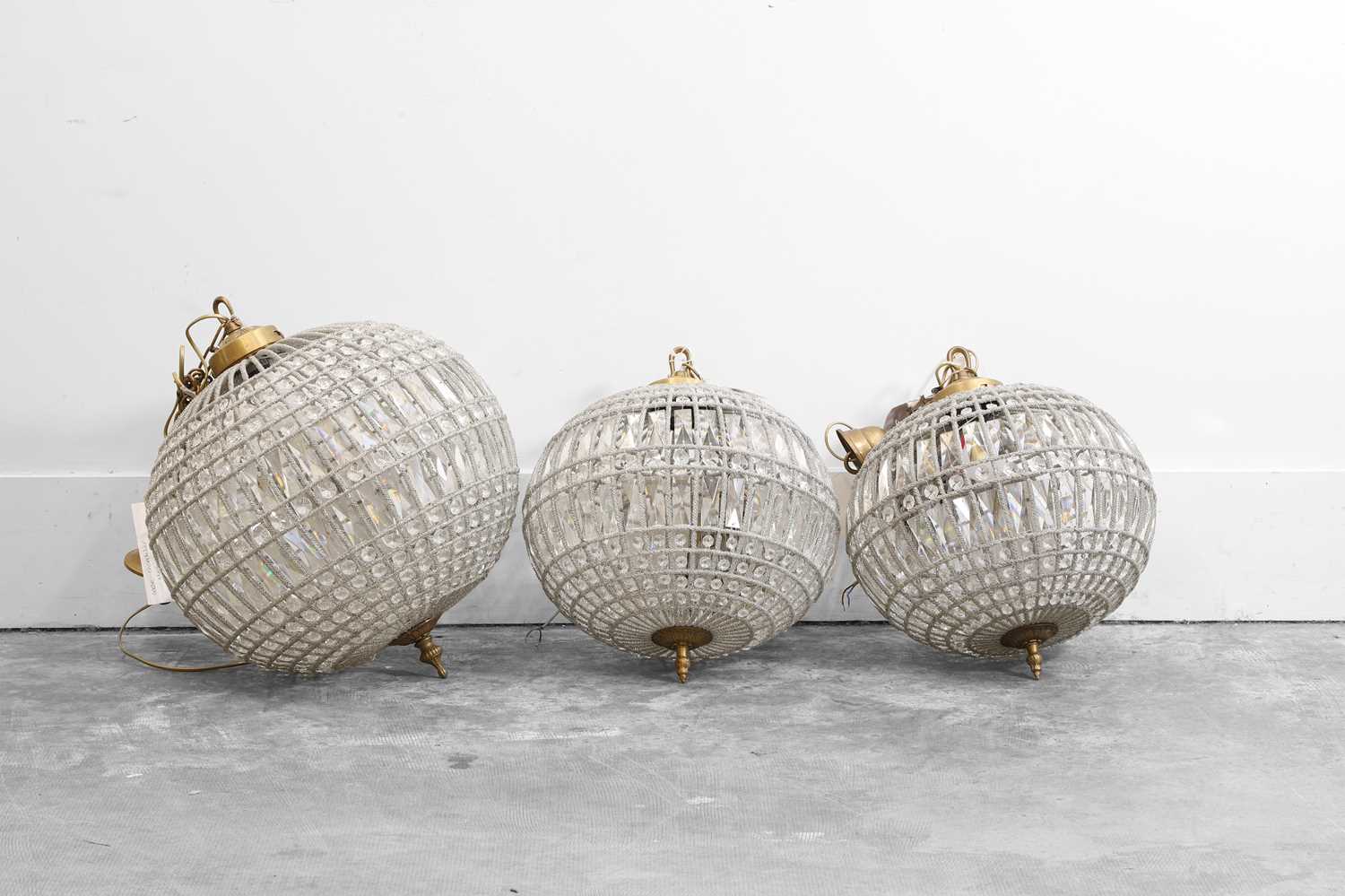 Lot 472 - A group of three cut-glass globe chandeliers