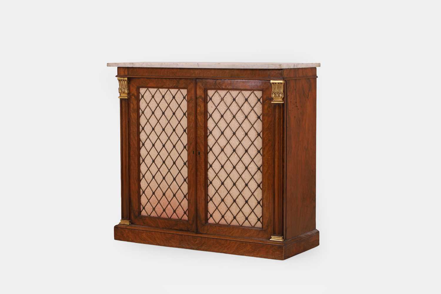 Lot 68 - A George IV-style walnut and parcel-gilt pier cabinet by Gillows