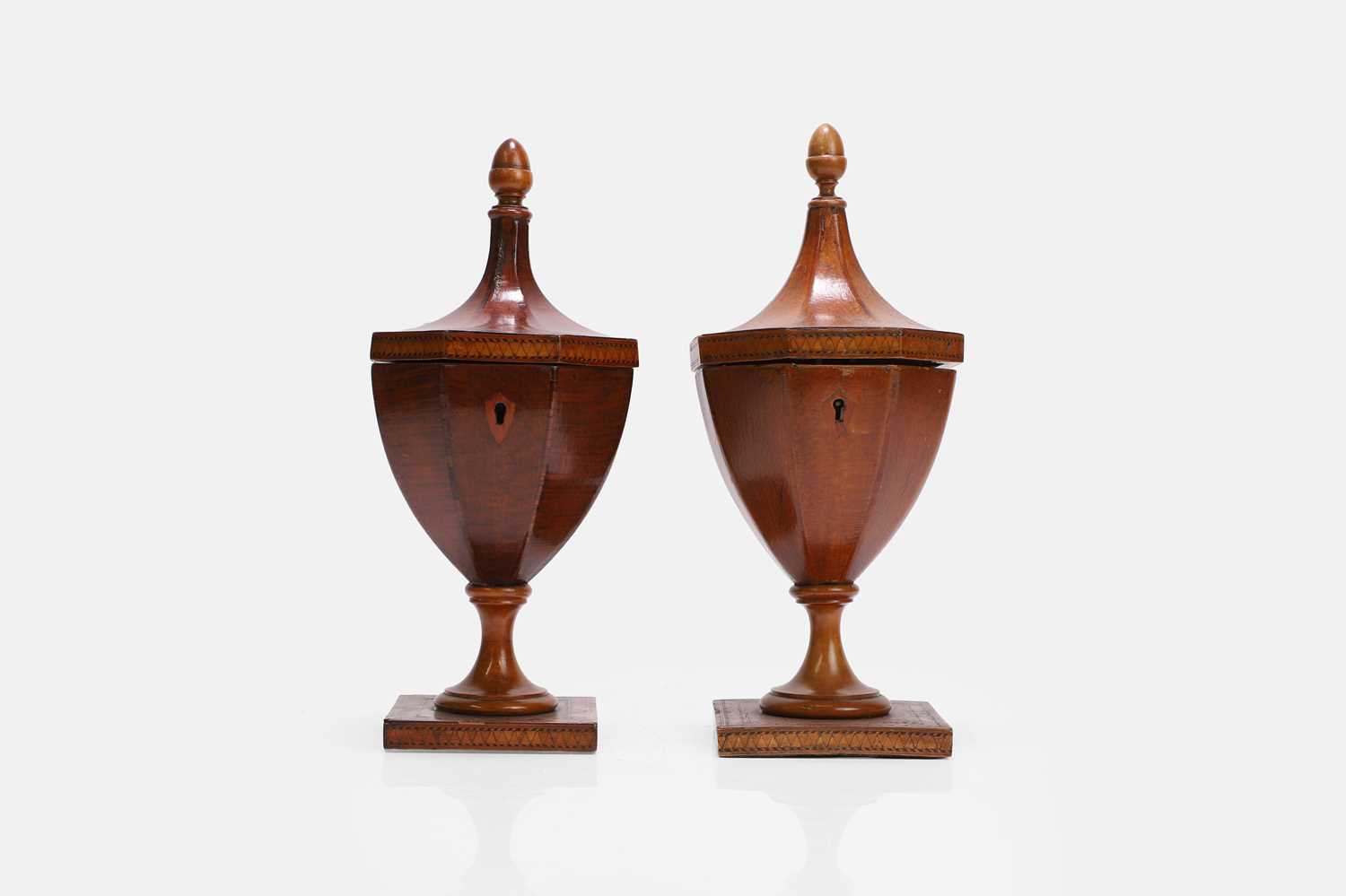 Lot 43 - A near pair of George III yew and satinwood urn tea caddies