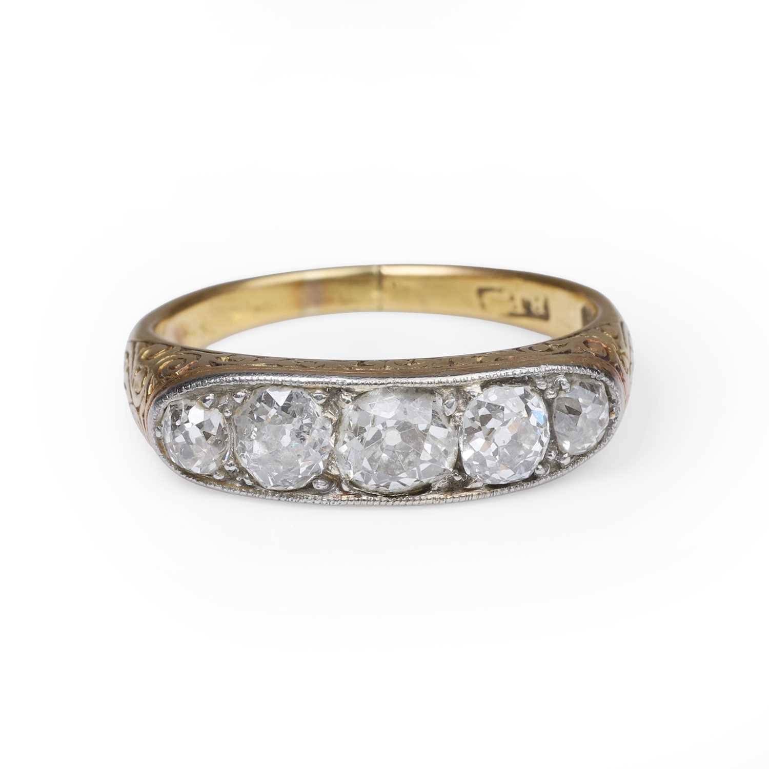 Lot 32 - A diamond five stone carved half hoop ring
