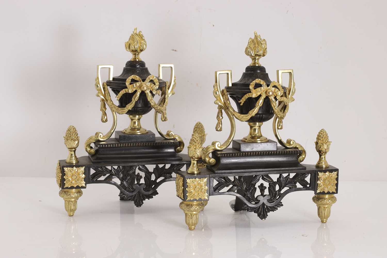 Lot 522 - A pair of gilt bronze and patinated metal chenets