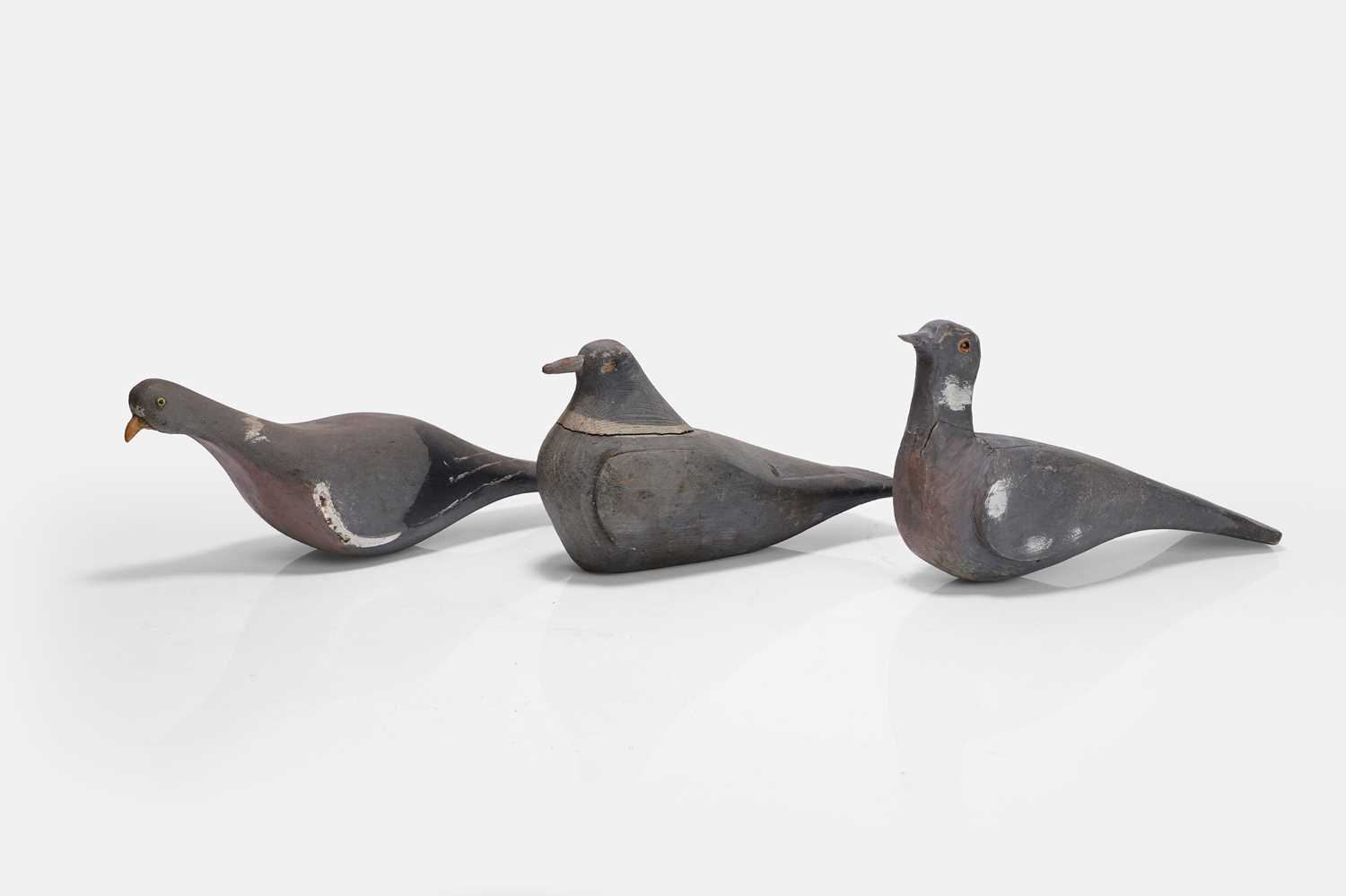 Lot 125 - A flight of three wooden decoy pigeons