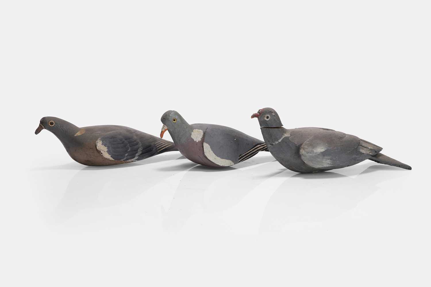 Lot 128 - A flight of three wooden decoy pigeons