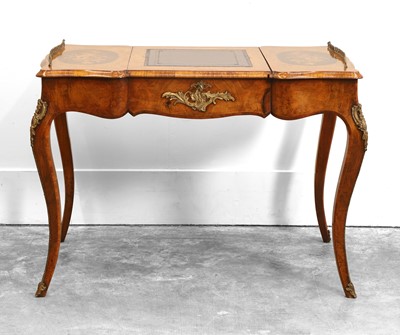 Lot 528 - A Louis XV style walnut and crossbanded shaped top bureau plat