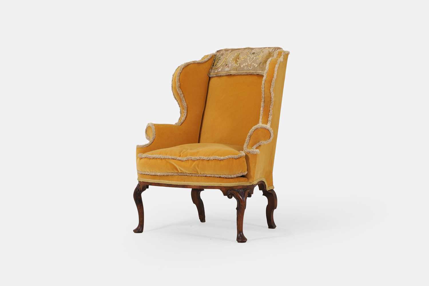 Lot 216 - A George I upholstered wing armchair