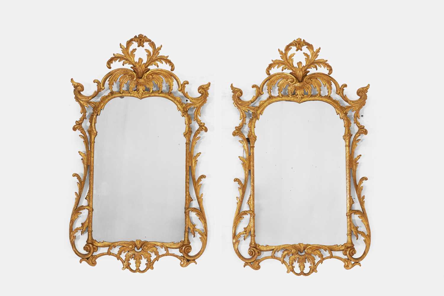 Lot 579 - A pair of early George III-style giltwood pier mirrors
