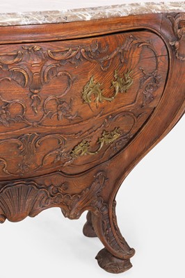 Lot 50 - A pair of rococo oak and marble bombé commodes