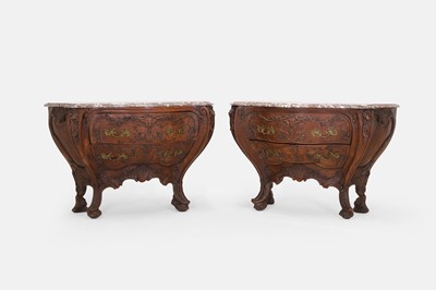 Lot 50 - A pair of rococo oak and marble bombé commodes