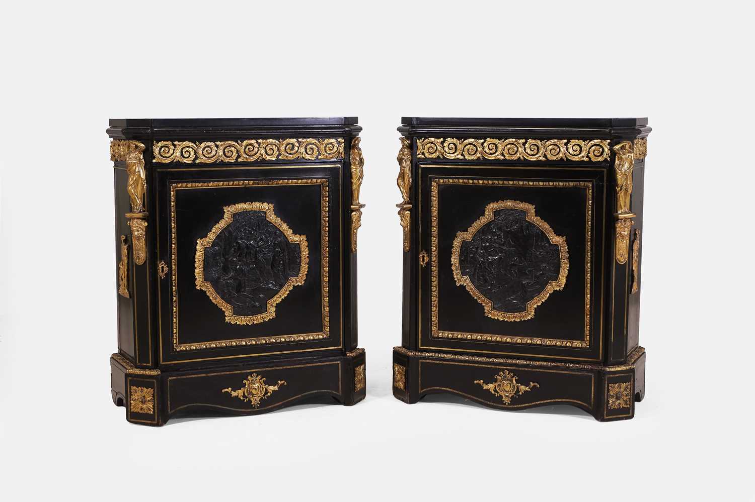 Lot 627 - A pair of Napoleon III ebonised and ormolu-mounted pier cabinets