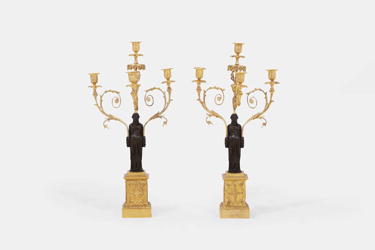 Lot 66 - A pair of large Regency patinated and gilt-bronze figural candelabra
