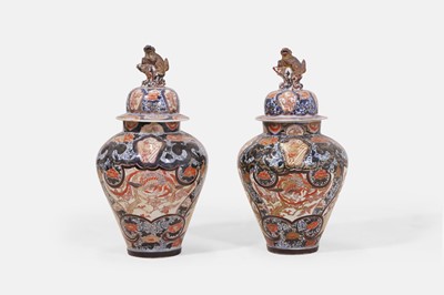 Lot 501 - A pair of Imari porcelain jars and covers