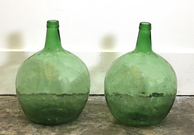 Lot 151 - A pair of green Glass Demijohns
