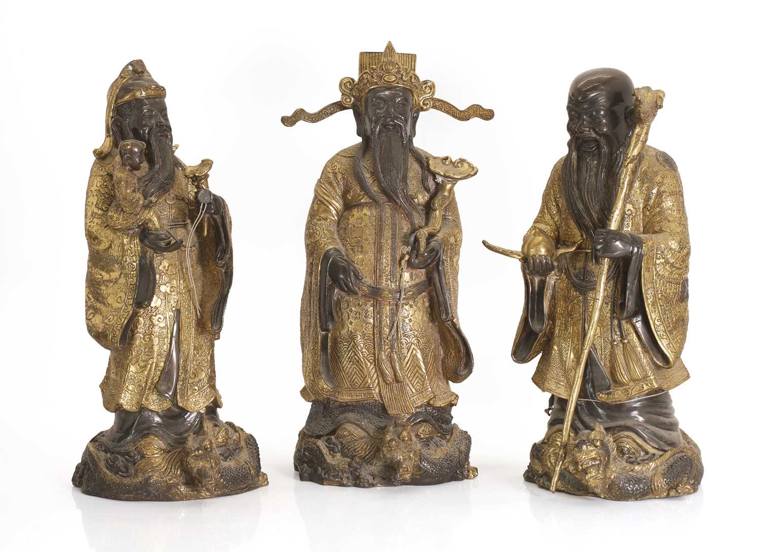 Lot 63 - Three Chinese gilt-brass figures of of 'Lu', 'Fu' and 'Shou'