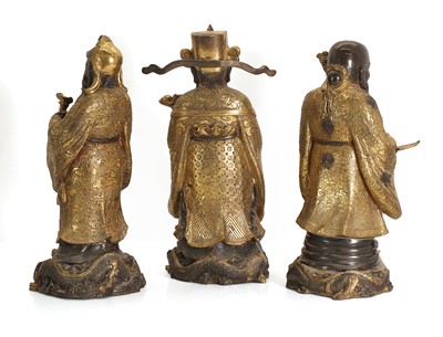 Lot 63 - Three Chinese gilt-brass figures of of 'Lu', 'Fu' and 'Shou'