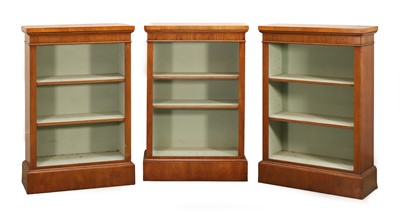 Lot 541 - Three walnut and oak banded open front bookcases