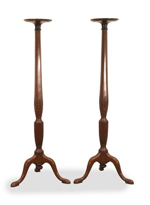 Lot 521 - A pair of mahogany torchere stands