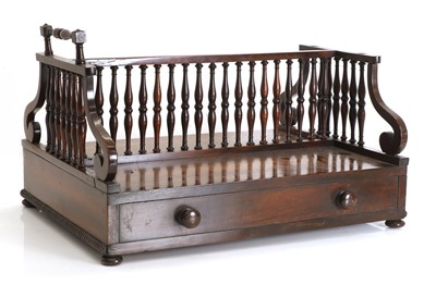 Lot 528 - A Regency rosewood double sided book trough