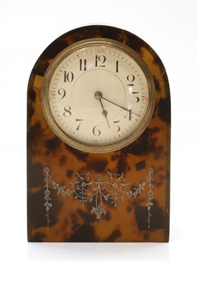 Lot 209 - A French tortoiseshell and silver inlaid mantel clock