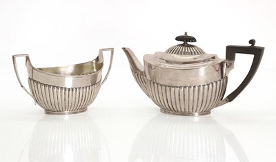 Lot 14 - A silver teapot and matching sugar bowl