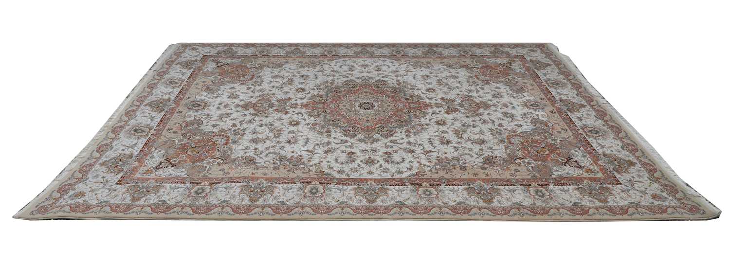 Lot 434 - A cream ground silk rug
