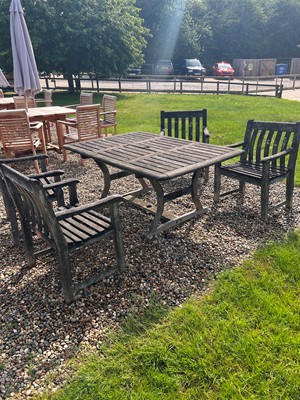 Lot 551 - A teak garden dining suite