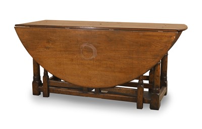 Lot 543 - A large oak double gate leg dining table and eight Windsor chairs
